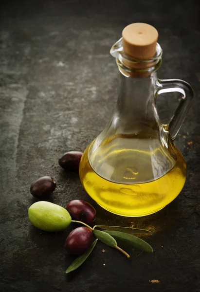 Olive oil on rustic background — Stock Photo, Image