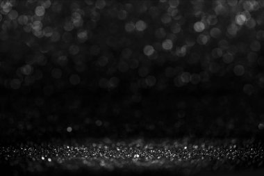 Kara Cuma Bokeh geçmişi. Zarif koyu bulanıklık tasarımı. Masada gümüş ve siyah pırıltılı ışıklar var. Kopyalama alanına sahip lüks soyut afiş.