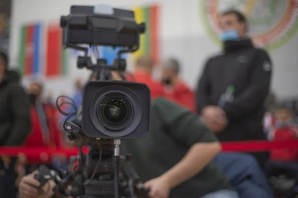 masked operator shoots a stream on the Internet broadcasting at a sport event