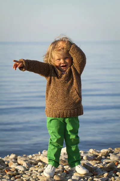 Girl in the autumn at the sea .