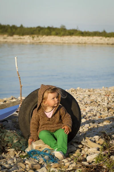 Girl in the autumn at the sea .