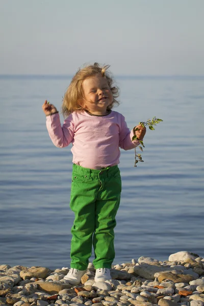 Girl in the autumn at the sea .