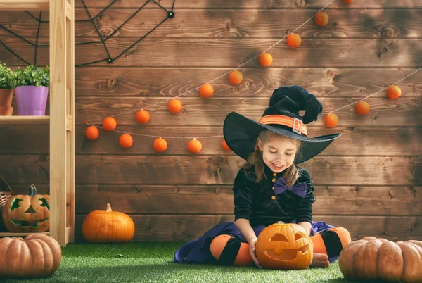 Little witch with a pumpkin — Stock Photo, Image