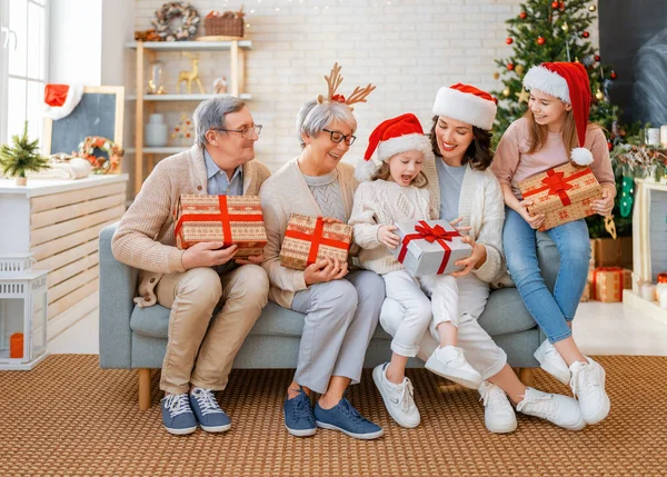 Merry Christmas Happy Holidays Cheerful Kids Presenting Gifts Mom Granny  Stock Photo by ©choreograph 523580328