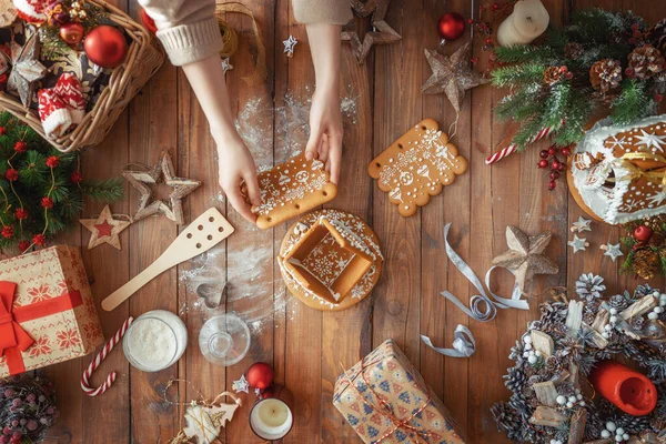 圣诞快乐 节日快乐 一个准备圣诞礼物的女人包 糖果和带装饰品的姜饼屋顶部视图 家庭传统 — 图库照片