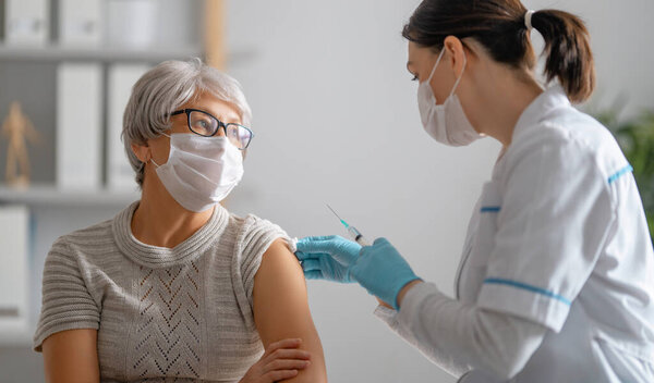Doctor Giving Senior Woman Vaccination Virus Protection Covid 2019 Stock Photo