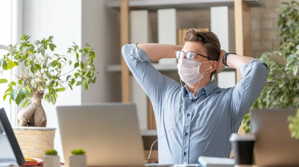 Hombre Joven Con Máscara Facial Está Trabajando Ordenador Portátil Oficina —  Fotos de Stock