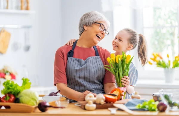Happy Family Kitchen Granddaughter Giving Flowers Her Grandmother — Stock Photo, Image