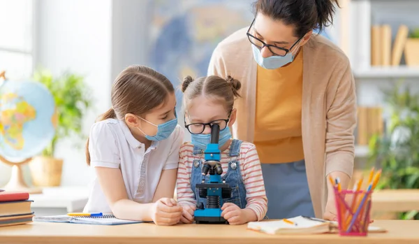 Back School Happy Children Wearing Facemasks Sitting Desks Girls Teacher — Stock Photo, Image