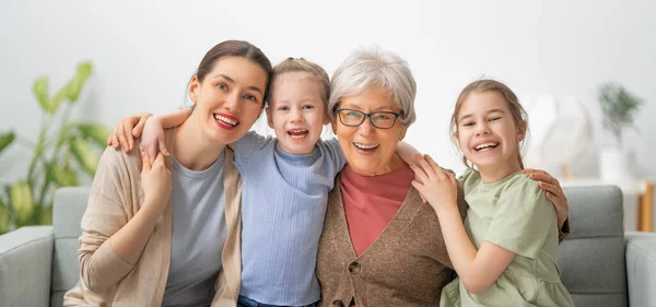 Nice Girls Mother Grandmother Hugging Enjoying Spending Time Together Home — Stock Photo, Image