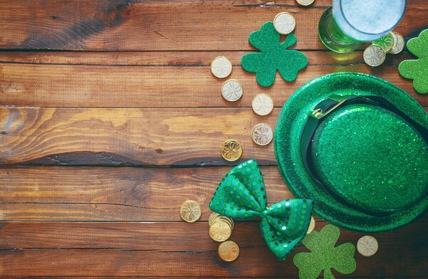 St. Patrick's Day decorations on wooden background.