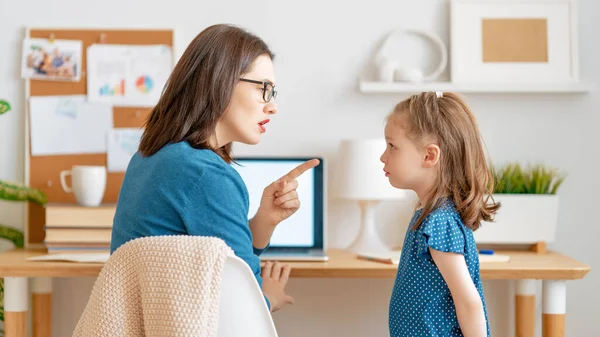 Woman working on a laptop. Noisy child and remote work from home.