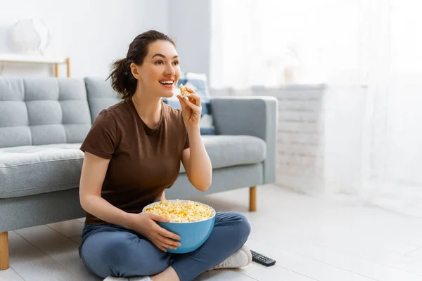 若い女性はテレビを見て ポップコーンと映画 家で時間を過ごす女の子 — ストック写真