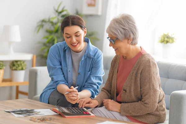 Two Women Sitting Sofa Paper Receipt Calculating Expenses Managing Family — Stock Photo, Image