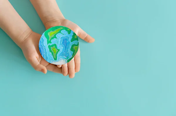 Child Holding Planet Hands Teal Background Earth Day Holiday Concept — Fotografia de Stock