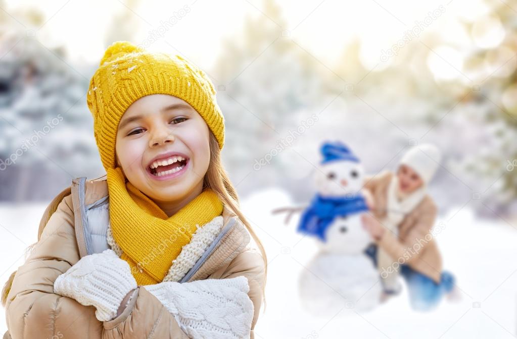 Mother and child girl on a winter walk