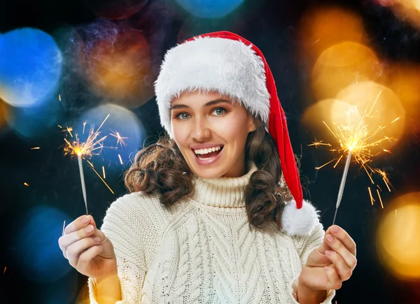 Beautiful woman holding sparkles. — Stock Photo, Image