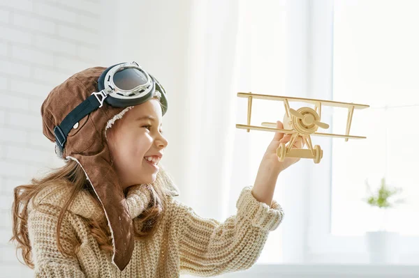 Girl playing with toy airplane — Stock Photo, Image