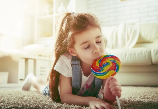 Girl eating candy — Stock Photo, Image