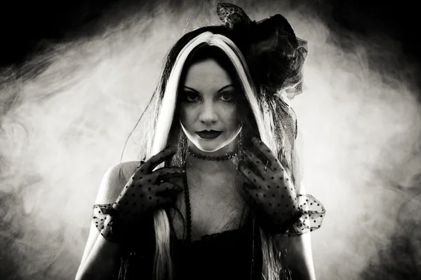 Portrait gothic girl in style clothes, shot over smoky backgroun Royalty Free Stock Photos