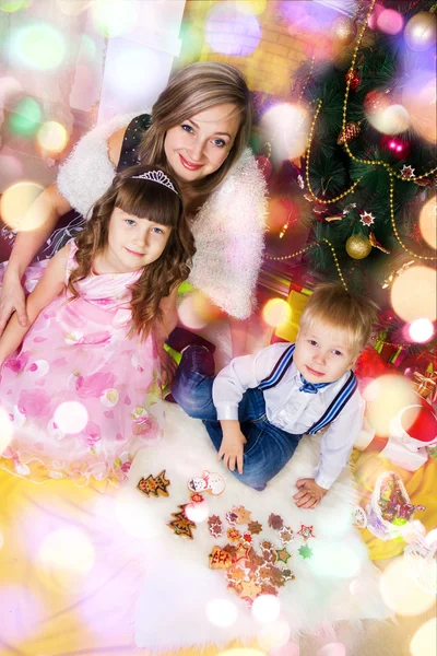 Happy mother and two her children in Christmas — Stock Photo, Image