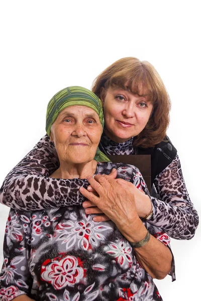 Old mother and the adult daughter in love to care, having embrac Royalty Free Stock Photos