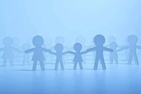 Paper family on blue background — Stock Photo, Image