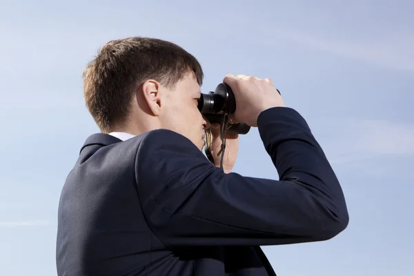 Affärsmannen ser ut genom en kikare — Stockfoto