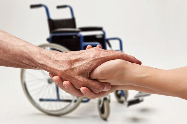 Hands of an elderly man holding the hand of a woman — Stock Photo, Image