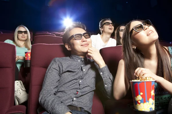 Young couple sitting at the cinema wearing 3d glasses, watching Royalty Free Stock Images
