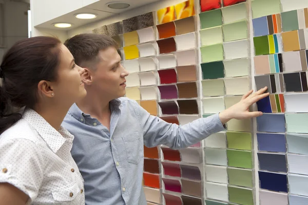 Pareja seleccione el color de pintura y busque muestras coincidentes en el hogar — Foto de Stock