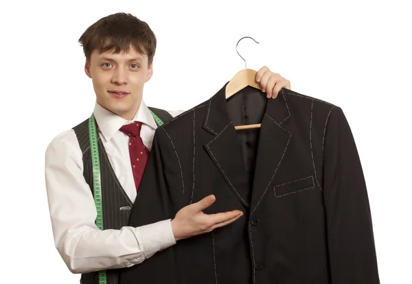 Taylor holds a mans suit isolated — Stock Photo, Image