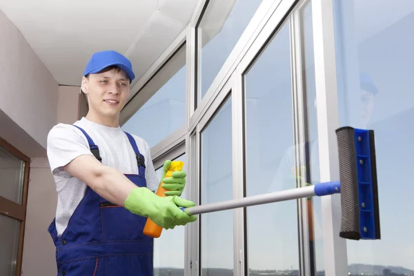 Jonge man wast venster — Stockfoto