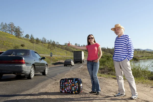 Hitchhiking travel couple at the route