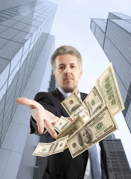 Businessman throwing dollar — Stock Photo, Image
