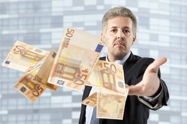Businessman throwing euro — Stock Photo, Image