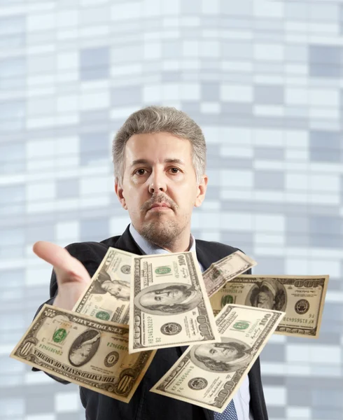 Businessman throwing dollar — Stock Photo, Image