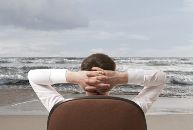 Kumsalda dinlenen bir iş adamı. 