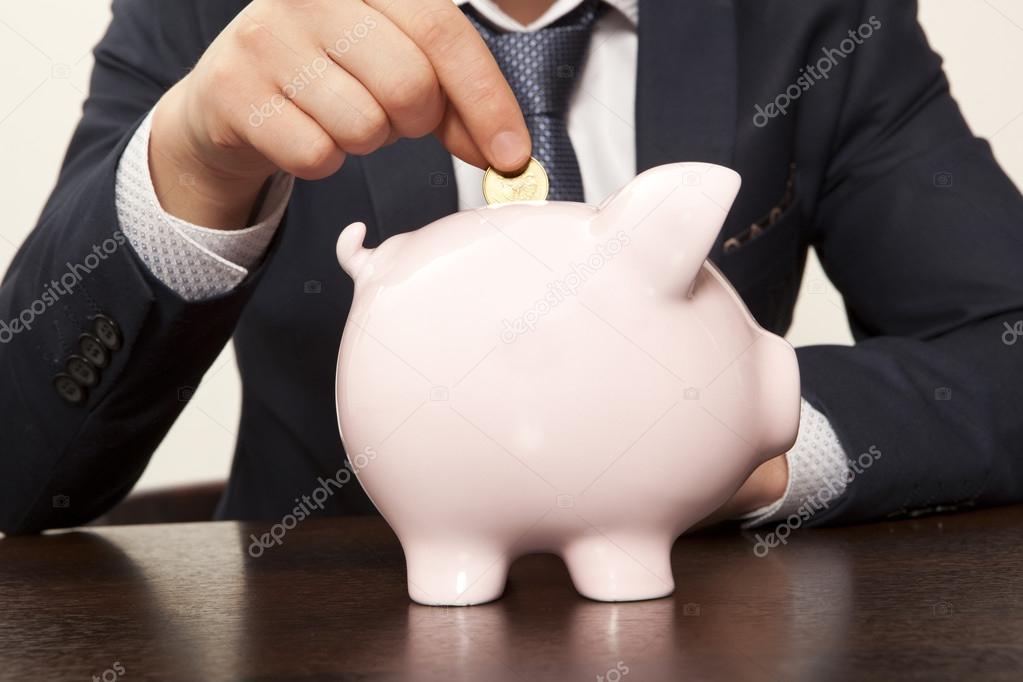 Businessman with pink piggy bank