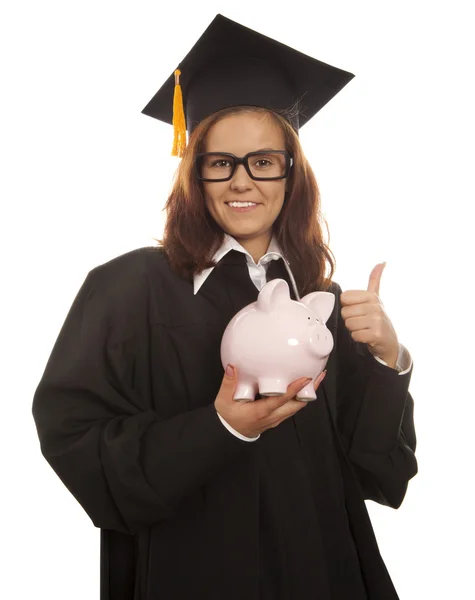 Graduation holding pink piggy bank — Stock Photo, Image