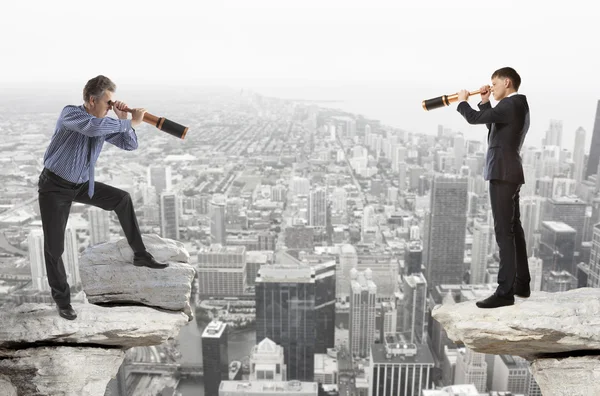 Businessman looks through a telescope — Stock Photo, Image