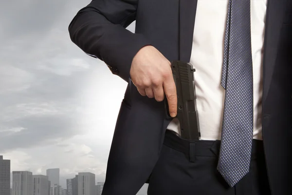 Businessman holding a gun — Stock Photo, Image