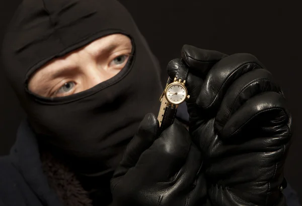 Thief with a golden watch — Stock Photo, Image