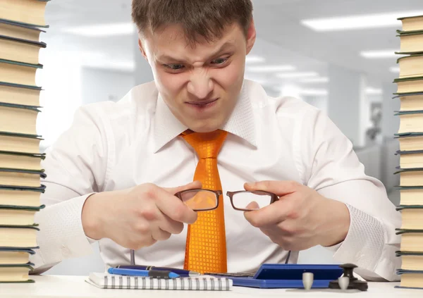 Angry businessman breaking glasses — Stock Photo, Image