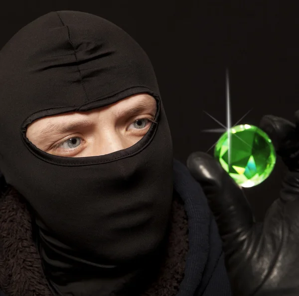 Thief with a big emerald — Stock Photo, Image