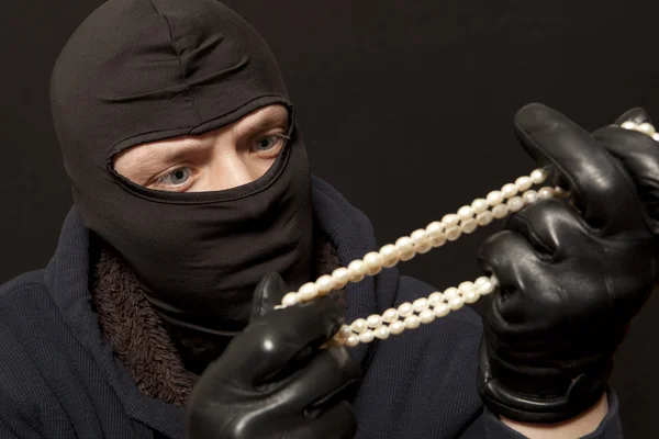 Thief with a pearl necklace — Stock Photo, Image