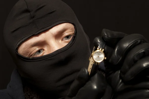 Thief with a golden watch — Stock Photo, Image