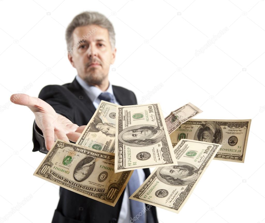 Businessman throwing dollar