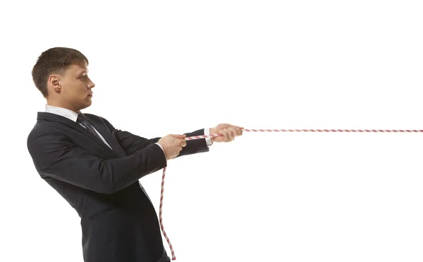 Businessman pulling a rope — Stock Photo, Image