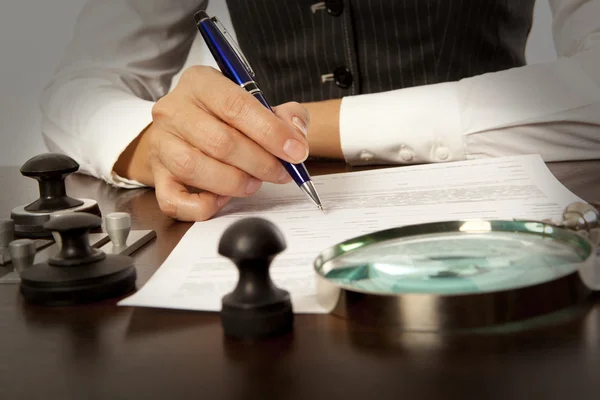 Notary signs the documents in office — Stock Photo, Image